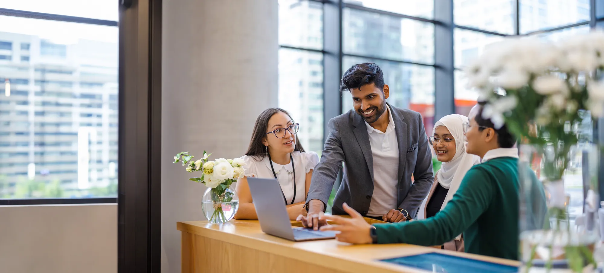 Group of people looking at a laptop